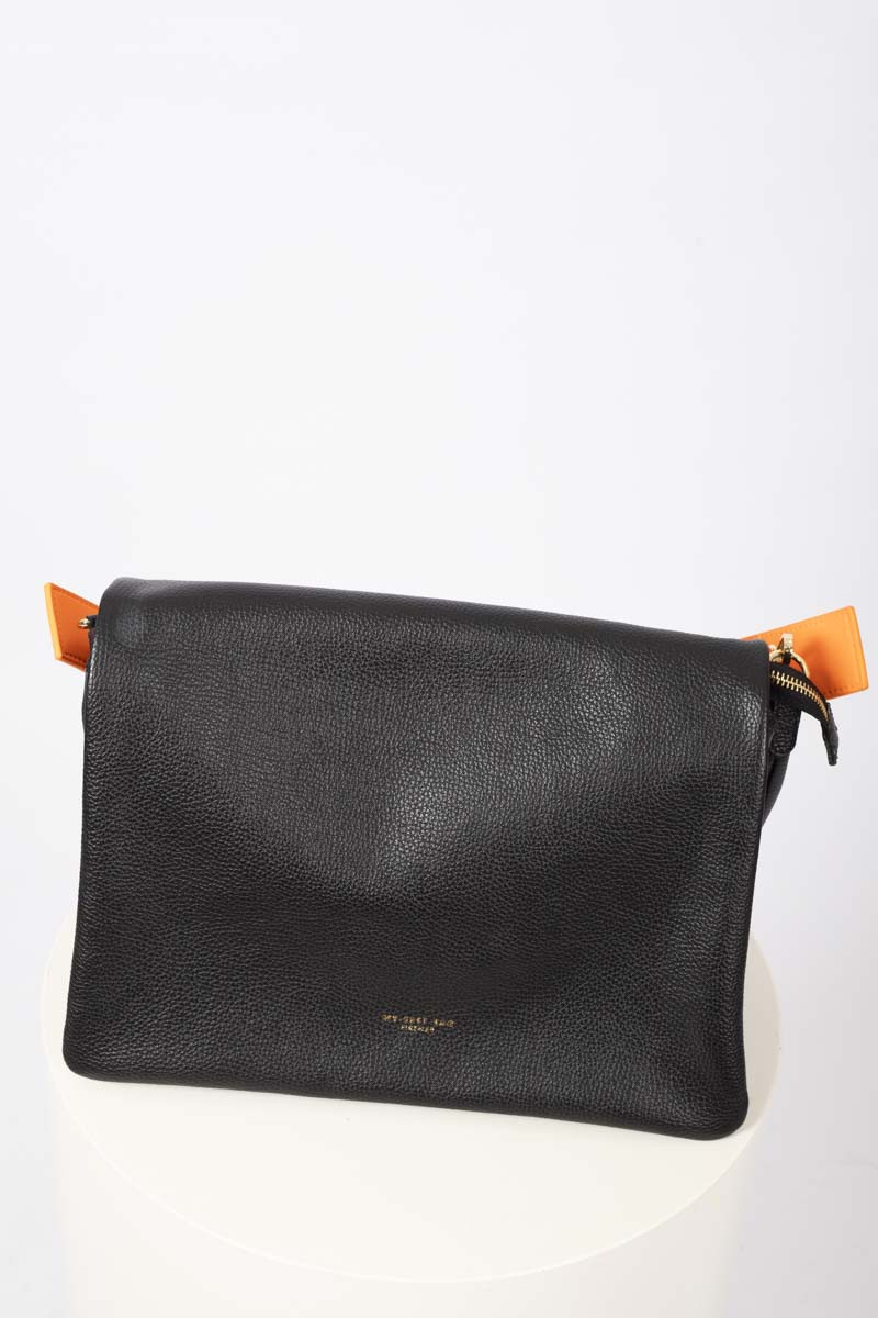 Black flap bag with orange shoulder strap