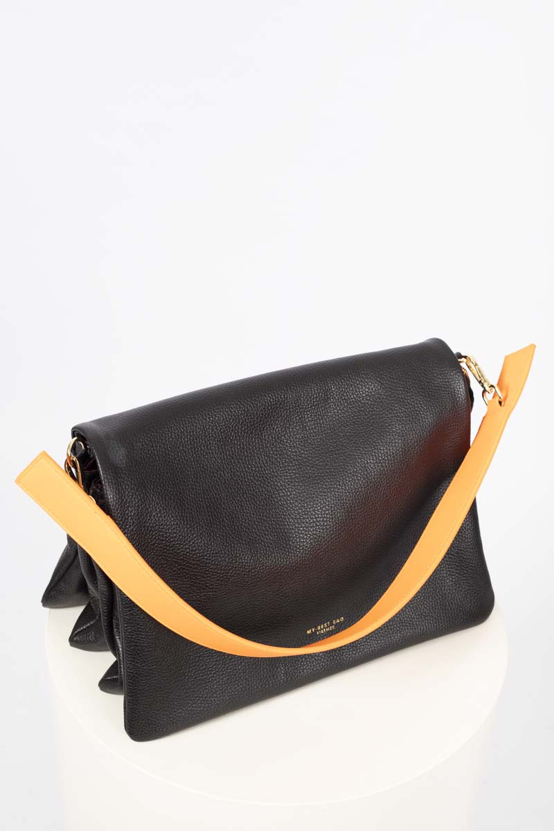 Black flap bag with orange shoulder strap