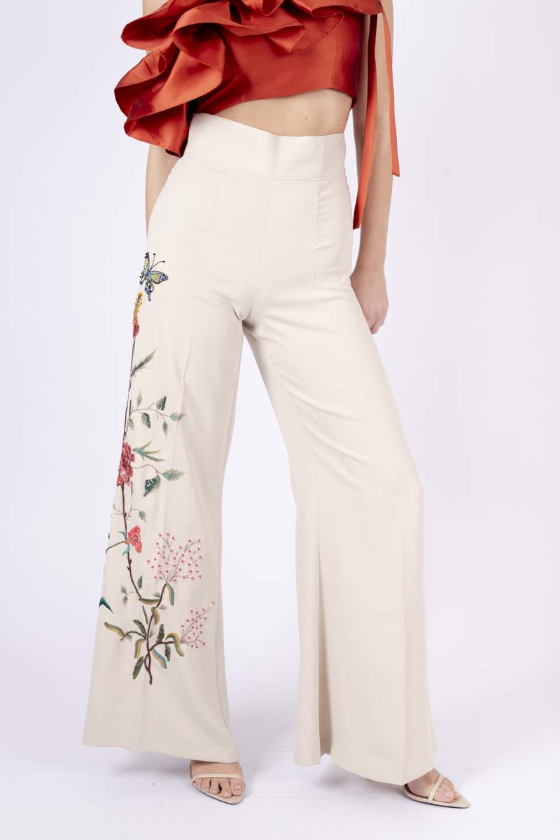 Trousers with floral appliqué